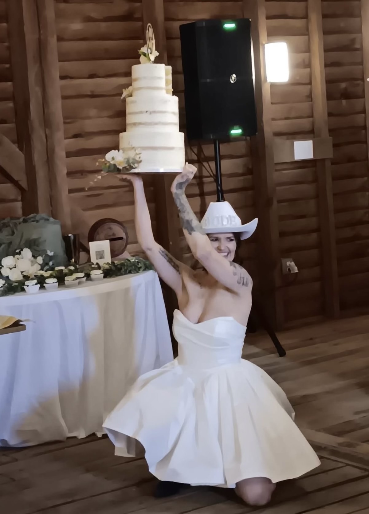 Elegant wedding cake creation featuring white frosting and fresh floral decorations